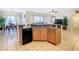 Modern kitchen island with stainless steel dishwasher open to the living room at 2632 Sand Hill Point Cir, Davenport, FL 33837
