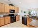 Modern kitchen with granite countertops, tile backsplash, and stainless steel appliances at 2632 Sand Hill Point Cir, Davenport, FL 33837