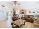 Spacious living room with tile floors, ceiling fan, and open access to the kitchen at 2632 Sand Hill Point Cir, Davenport, FL 33837
