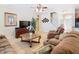 Comfortable living room featuring neutral tones, tile flooring, and staircase access at 2632 Sand Hill Point Cir, Davenport, FL 33837