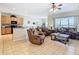 Comfortable living room with tile floors, plush seating, and abundant natural light at 2632 Sand Hill Point Cir, Davenport, FL 33837