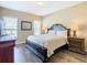 Comfortable main bedroom showcases wood floors, natural light, and classic decor at 2632 Sand Hill Point Cir, Davenport, FL 33837