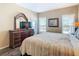 Bright main bedroom with an outside patio access, a large dresser, and ample natural light at 2632 Sand Hill Point Cir, Davenport, FL 33837