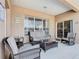 Covered patio with comfortable wicker furniture and sliding glass door access at 2632 Sand Hill Point Cir, Davenport, FL 33837