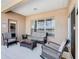 Covered patio with wicker seating, coffee table, and view to backyard at 2632 Sand Hill Point Cir, Davenport, FL 33837