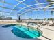 Backyard pool and spa with a screened enclosure and lounge chairs at 2632 Sand Hill Point Cir, Davenport, FL 33837