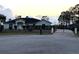 Lovely single story home at dusk with black wrought iron fence and automatic entry gate at 2639 Janet Ct, Deltona, FL 32738