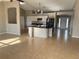 Open-concept living space with tile flooring, a kitchen island, and modern lighting at 2639 Janet Ct, Deltona, FL 32738