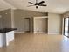 Spacious living room featuring tile floors, neutral paint, and a modern ceiling fan at 2639 Janet Ct, Deltona, FL 32738