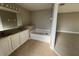 Relaxing main bathroom featuring a corner tub, dual sinks, and neutral tones at 2639 Janet Ct, Deltona, FL 32738