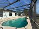 Beautiful in-ground pool with screened enclosure and view of home exterior at 2639 Janet Ct, Deltona, FL 32738