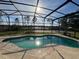 A screened in in-ground pool basks in the sunlight, offering a private retreat at 2639 Janet Ct, Deltona, FL 32738