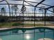 Sparkling in-ground pool within a screened enclosure, providing serene outdoor living at 2639 Janet Ct, Deltona, FL 32738