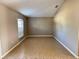 Empty room featuring neutral walls, tile floors, and a window with blinds at 2639 Janet Ct, Deltona, FL 32738