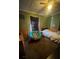 Cozy bedroom with a comfortable bed, chair and vintage decor at 310 Lake Ave, Dundee, FL 33838