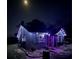 Charming home at night with festive decorative lighting, enhanced curb appeal and a cozy feel at 310 Lake Ave, Dundee, FL 33838