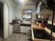 Modest kitchen with essential appliances and vintage backsplash at 310 Lake Ave, Dundee, FL 33838