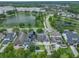 An aerial view showcasing the homes, landscaping, and a nearby lake at 3966 Avalon Park West Blvd, Orlando, FL 32828