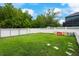 A spacious backyard with lush green grass, a white fence, and a play area for children to enjoy at 3966 Avalon Park West Blvd, Orlando, FL 32828