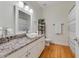 Bathroom featuring a granite countertop, stylish sink, and a mirror cabinet with white trim at 3966 Avalon Park West Blvd, Orlando, FL 32828