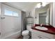 The bathroom features a window, grey shower curtain, and red countertop at 3966 Avalon Park West Blvd, Orlando, FL 32828
