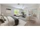 A staged bedroom features two chairs, a sofa, and large mirrored closet doors at 3966 Avalon Park West Blvd, Orlando, FL 32828