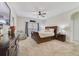 Spacious bedroom with a ceiling fan, a dresser, and a large bed with pillows and blankets at 3966 Avalon Park West Blvd, Orlando, FL 32828