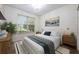 Bright bedroom features a window, chandelier, neutral walls, and minimalist décor at 3966 Avalon Park West Blvd, Orlando, FL 32828