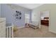 Bedroom featuring a crib and charming decor, creating a cozy and inviting atmosphere at 3966 Avalon Park West Blvd, Orlando, FL 32828
