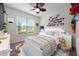 Cozy bedroom with light-colored walls and a window, plus colorful Disney decor at 3966 Avalon Park West Blvd, Orlando, FL 32828