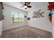 A vacant bedroom with light-colored walls and a ceiling fan plus a window at 3966 Avalon Park West Blvd, Orlando, FL 32828