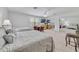 Spacious bedroom featuring two beds, a seating area, ceiling fan, and mirrored closet doors at 3966 Avalon Park West Blvd, Orlando, FL 32828
