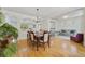 Open-concept dining room with hardwood floors connecting to the living area and kitchen at 3966 Avalon Park West Blvd, Orlando, FL 32828