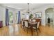 Elegant dining room with hardwood floors, a chandelier, and natural light from the glass doors at 3966 Avalon Park West Blvd, Orlando, FL 32828