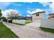 A well-maintained home exterior with a long driveway, a green lawn, and a white fence for added privacy at 3966 Avalon Park West Blvd, Orlando, FL 32828
