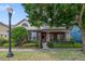 Charming red brick home featuring a cozy covered porch and manicured front yard at 3966 Avalon Park West Blvd, Orlando, FL 32828