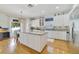 Bright kitchen featuring white cabinets, granite countertops, and a large center island at 3966 Avalon Park West Blvd, Orlando, FL 32828
