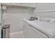 Laundry room with white appliances, neutral walls, and tile flooring at 3966 Avalon Park West Blvd, Orlando, FL 32828