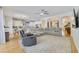 Spacious open-concept living room with hardwood floors, a large sectional, and modern ceiling fan at 3966 Avalon Park West Blvd, Orlando, FL 32828