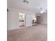 A spacious living room shows doorway to the bathroom and glass doors to the outside at 3966 Avalon Park West Blvd, Orlando, FL 32828