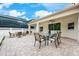 Outdoor patio with brick flooring, covered area, comfortable seating, and a table for outdoor dining at 3966 Avalon Park West Blvd, Orlando, FL 32828