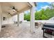 Spacious covered patio with brick flooring, ceiling fans, and ample space for outdoor entertaining and grilling at 3966 Avalon Park West Blvd, Orlando, FL 32828