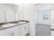 Double vanity bathroom featuring granite countertops, modern sinks and cabinetry, and a connecting bedroom at 4027 Copperleaf Ln, Poinciana, FL 34759