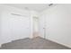 Carpeted bedroom with double door closet and an entryway at 4027 Copperleaf Ln, Poinciana, FL 34759