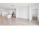 Open-concept kitchen featuring white cabinets, stainless steel appliances, and a large island with seating at 4027 Copperleaf Ln, Poinciana, FL 34759