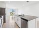 Bright kitchen island offers granite counters, a stainless steel sink, and stainless dishwasher at 4027 Copperleaf Ln, Poinciana, FL 34759