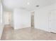 Bright, open living room with tile floors, neutral walls, and ample natural light streaming in from a window at 4027 Copperleaf Ln, Poinciana, FL 34759