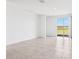 Spacious living room features tile flooring and sliding glass doors with a beautiful outdoor view at 4027 Copperleaf Ln, Poinciana, FL 34759