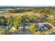 An aerial view of the neighborhood and its surroundings, featuring many trees and a vast green space in the distance at 404 W 19Th St, Sanford, FL 32771