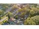 Aerial neighborhood shot with tree coverage and backyard sheds and a glimpse of the surrounding streetscape at 404 W 19Th St, Sanford, FL 32771